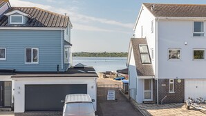 A residential area with houses, a garage, and a boat dock. - Modern town house situated in a quiet location with views across the harbour (Christchurch)