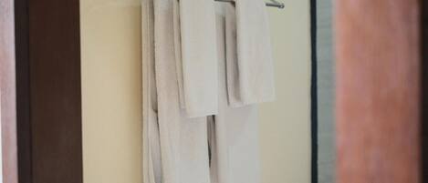 A bathroom with a towel rack holding two towels.