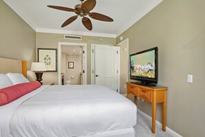 A hotel room with a bed, a ceiling fan, a television on a wooden stand, and a bathroom visible through an open door. - 2 Honua Kai Villas | Ocean Front | Sleeps 10 | Free Car w/ 6+ Nights | ML-2717 (Lahaina)