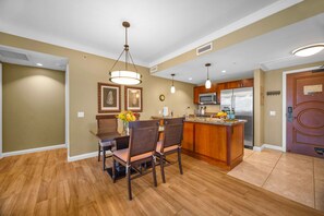 A modern kitchen with wooden cabinets, a central island, and stainless steel appliances. - 2 Honua Kai Villas | Ocean Front | Sleeps 12 | Free Car w/ 6+ Nights | ML-2780 (Lahaina)