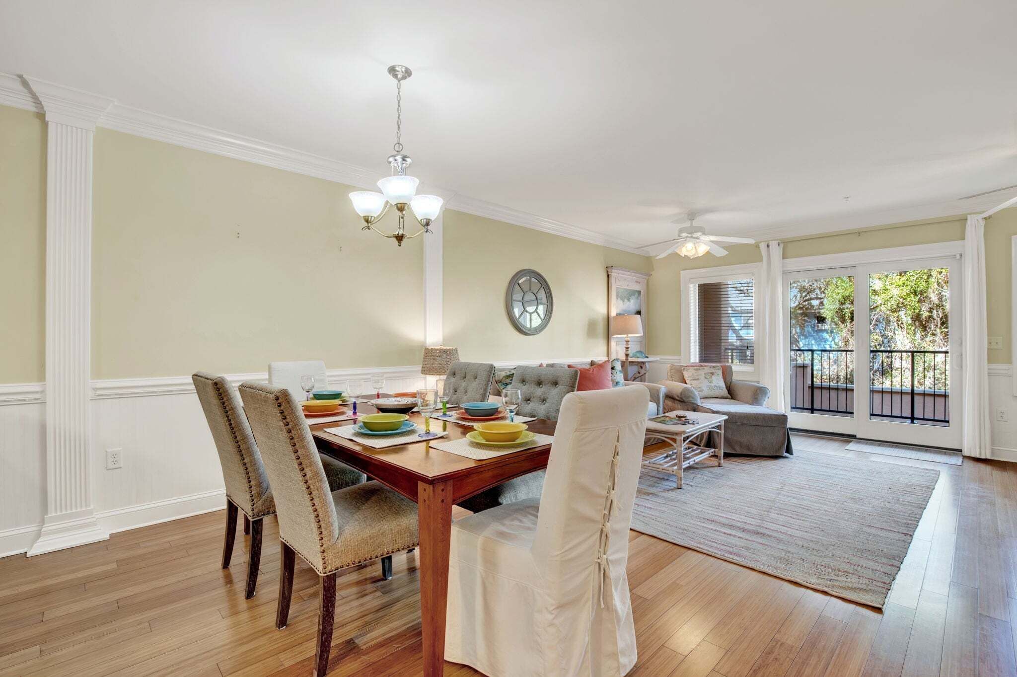 A dining area with a wooden table, chairs, and a chandelier.