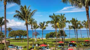 A resort with palm trees, a pool, and a view of the ocean. - Honua Kai | Ocean View 8 BR, Sleeps 24 | Car Incl. w/ 6+ Nights | HKK ML-3167 by KBM (Lahaina)