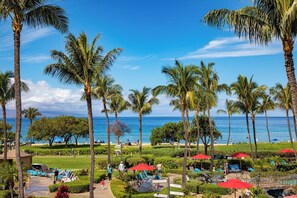 A resort with palm trees, a pool, and a view of the ocean. - Honua Kai | Ocean View 8 BR, Sleeps 24 | Car Incl. w/ 6+ Nights | HKK ML-3167 by KBM (Lahaina)