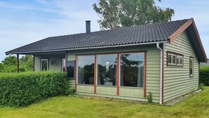 A single-story house with a sloped roof, large windows, and a chimney. - Nice home in Karrebæksminde with WiFi (Karrebæksminde)