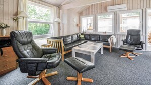 A room with a sectional sofa, two leather armchairs, a small coffee table, and a wooden cabinet. - Pet friendly home in Tarm with WiFi (Tarm)