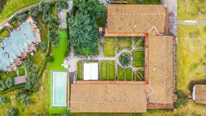 An aerial view of a property with a large central building, a swimming pool, and surrounding green spaces. - Residence La Perla - Apt 39, Monte Isola, Italy (Monte Isola)