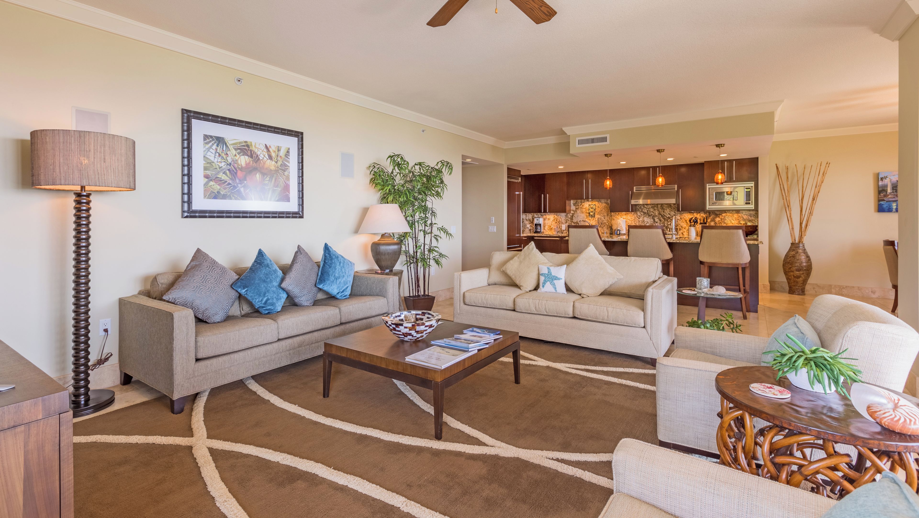A modern living room with two sofas, a coffee table, and a dining area with a wooden table and chairs.