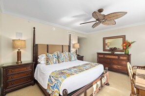 A bedroom with a bed, a nightstand, a dresser, a mirror, and a ceiling fan. - NEW! KBM Resorts | 3 FREE CARS | Honua Kai Konea | Ocean View Resort | Spacious 8-Bedroom Multi-Unit Listing! HK ML-3383 (Lahaina)