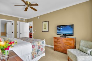 A hotel room with a bed, a television, a dresser, and a chair. - Honua Kai | Ocean View 5 BR, Sleeps 14 | Car Incl. w/ 6+ Nights | HKK ML-3395 by KBM (Lahaina)