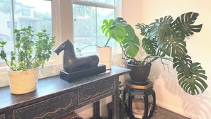 A room with a window, a wooden desk, and various potted plants. - Polka Dot Cozy Retreat，Quiet, Clean & Comfortable Stay (Chino Hills)
