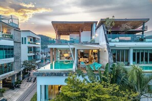 A modern multi-story building with a rooftop pool, outdoor seating, and a covered terrace. - Seaview Rooftop Pool Villa Near Beach V210 (Rawai)