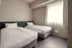 A hotel room with two beds, a window with curtains, and a wall-mounted air purifier. - HUBEX AKIHABARA (Tokyo)