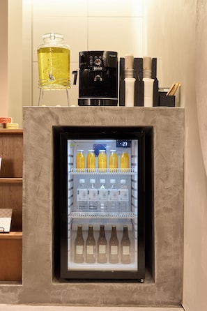 A beverage dispenser with a coffee machine and a refrigerator stocked with bottled drinks. - HUBEX AKIHABARA (Tokyo)