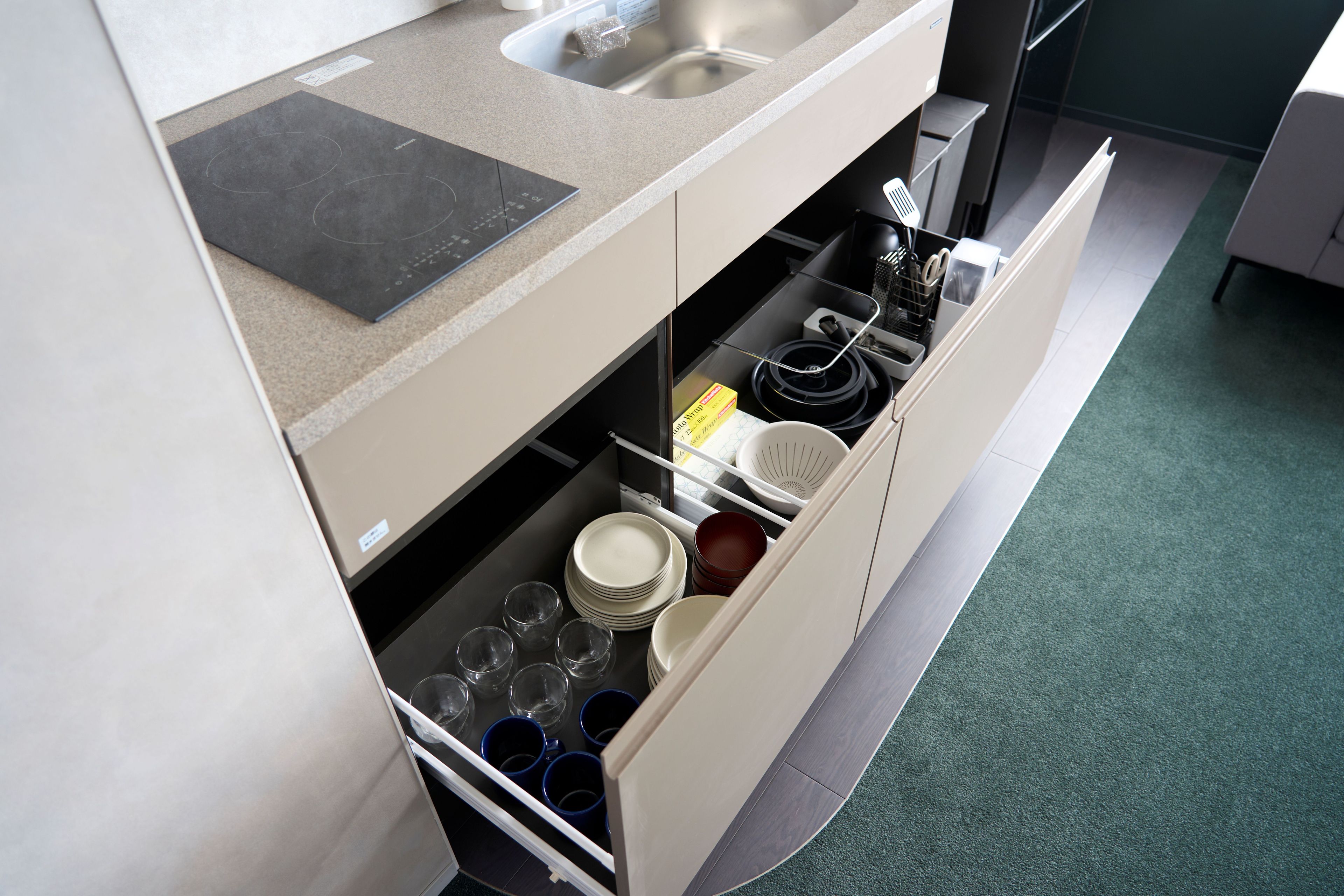 A kitchen with a built-in dishwasher, a sink, and a countertop.