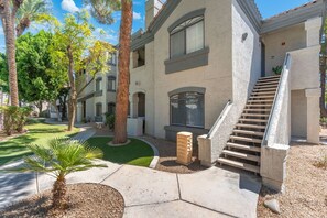A residential building with a staircase, a small garden, and a palm tree. - Spacious 2BR 2BA Condo Getaway for 6 (Scottsdale)