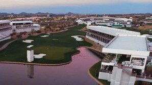 Un parcours de golf avec un obstacle d’eau, entouré de bâtiments sur lesquels on peut lire l’inscription « PENSEZ VERT ».
