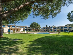 A hotel with multiple buildings, a swimming pool, and a well-maintained lawn. - Pool retreat at Clube da Bemposta (Alvor)