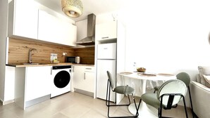 A modern kitchen with a washing machine, a microwave, and a refrigerator. - Welooveyou Coral your place to discover the island (Costa Calma (incl. Urbanización Cañada del Río))