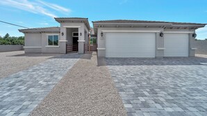 A residential property with a garage, a covered driveway, and a small entrance.