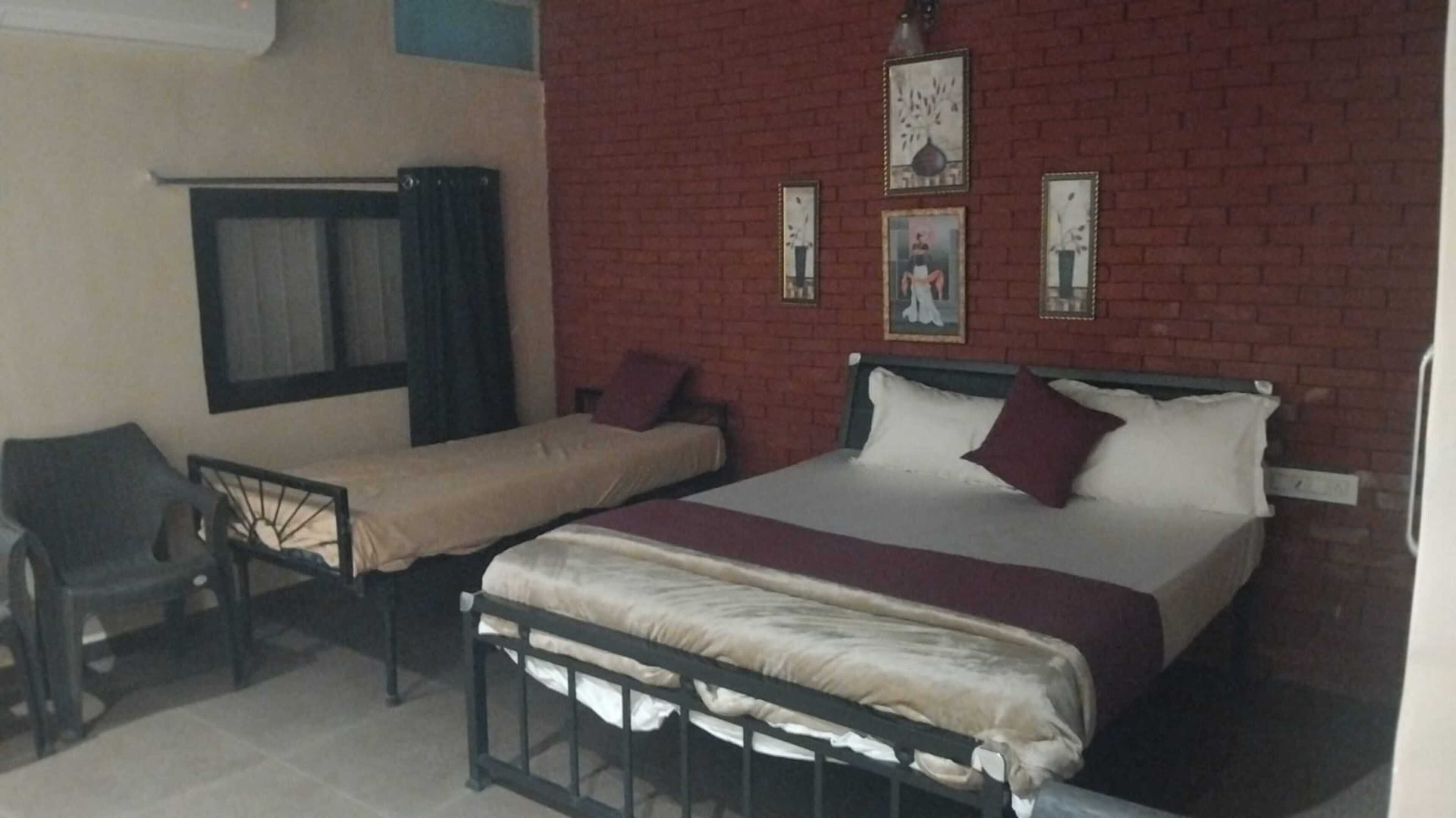 A room with a bed, a chair, and a window.