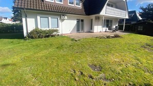 A two-story house with a sloped roof, a balcony, and a front porch. - Family-friendly with garden & private parking lot Suitable for fitters & groups (Oldenburg (Oldb))
