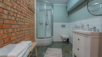 A bathroom with a shower, toilet, and sink.