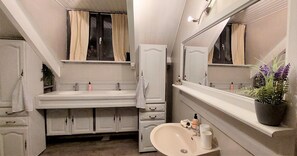 A narrow bathroom with a sink, mirror, and cabinets. - House Ardennes Blue in Theux Near Spa (Theux)