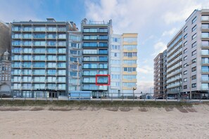 A multi-story hotel with a modern architectural design, featuring balconies and large windows. - Apartment in Middelkerke With Sea View (Middelkerke)