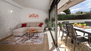 A modern living room with a sofa, coffee table, and a painting on the wall. - Finca with pool and garden, pets welcome (Vižinada)