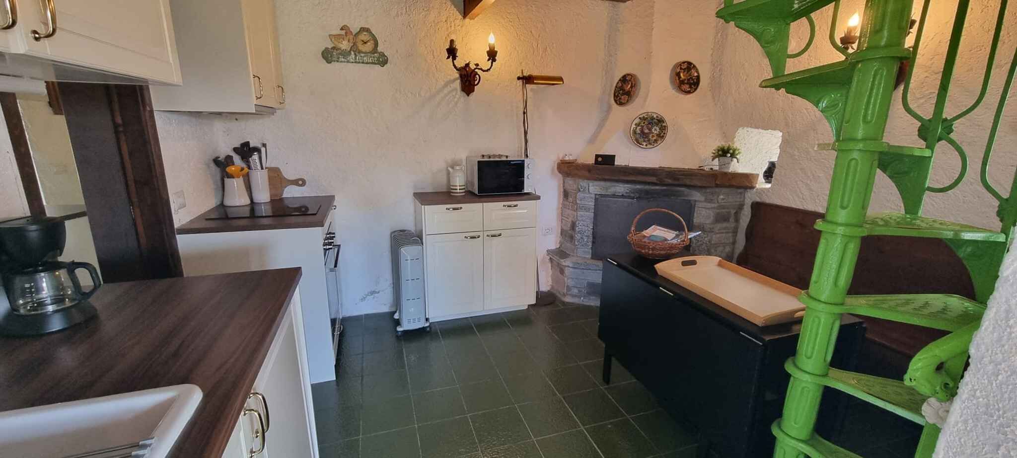 A compact kitchen with a coffee maker, a microwave, and a small refrigerator.