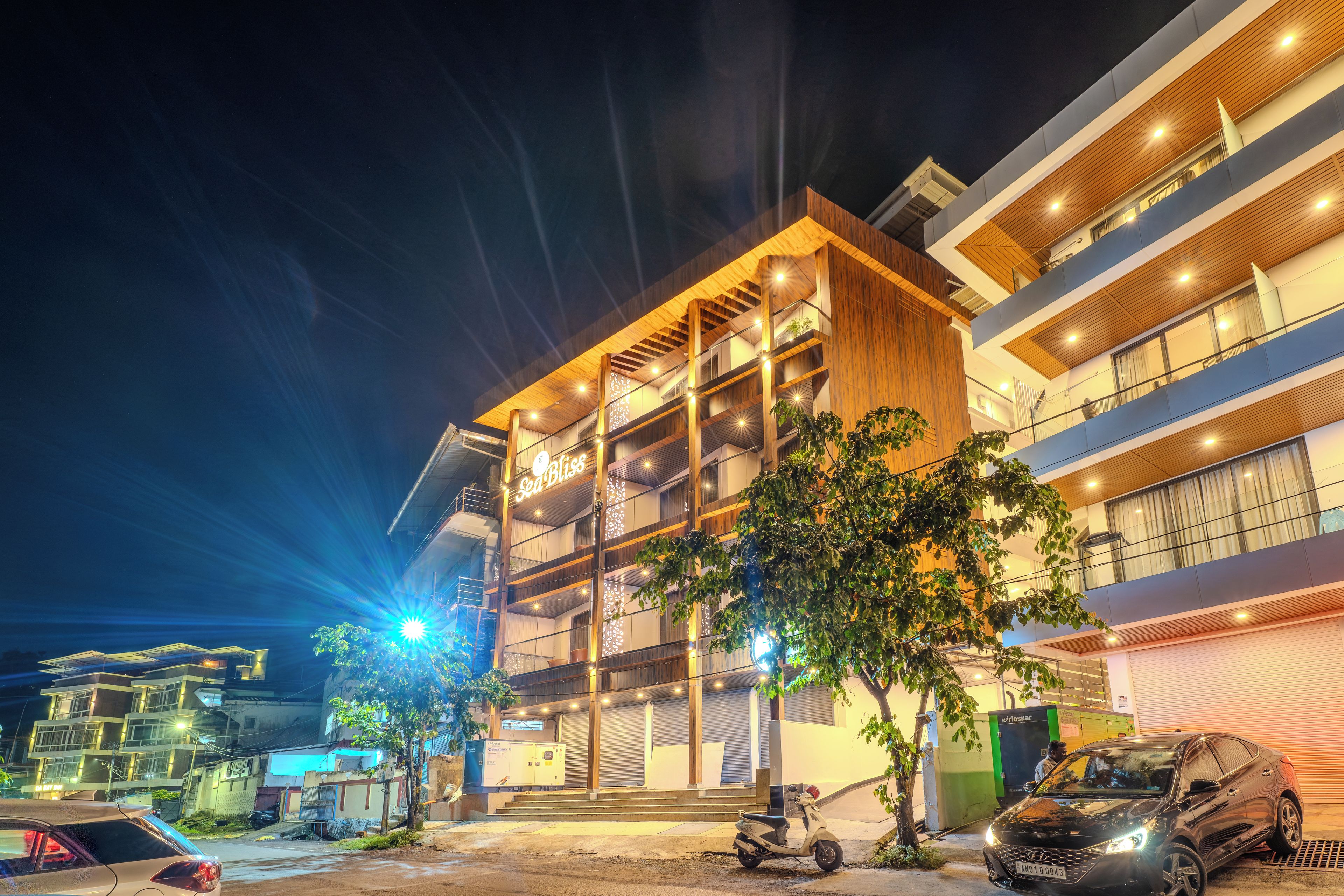 A multi-story hotel with a modern design, featuring balconies and a prominent signage.