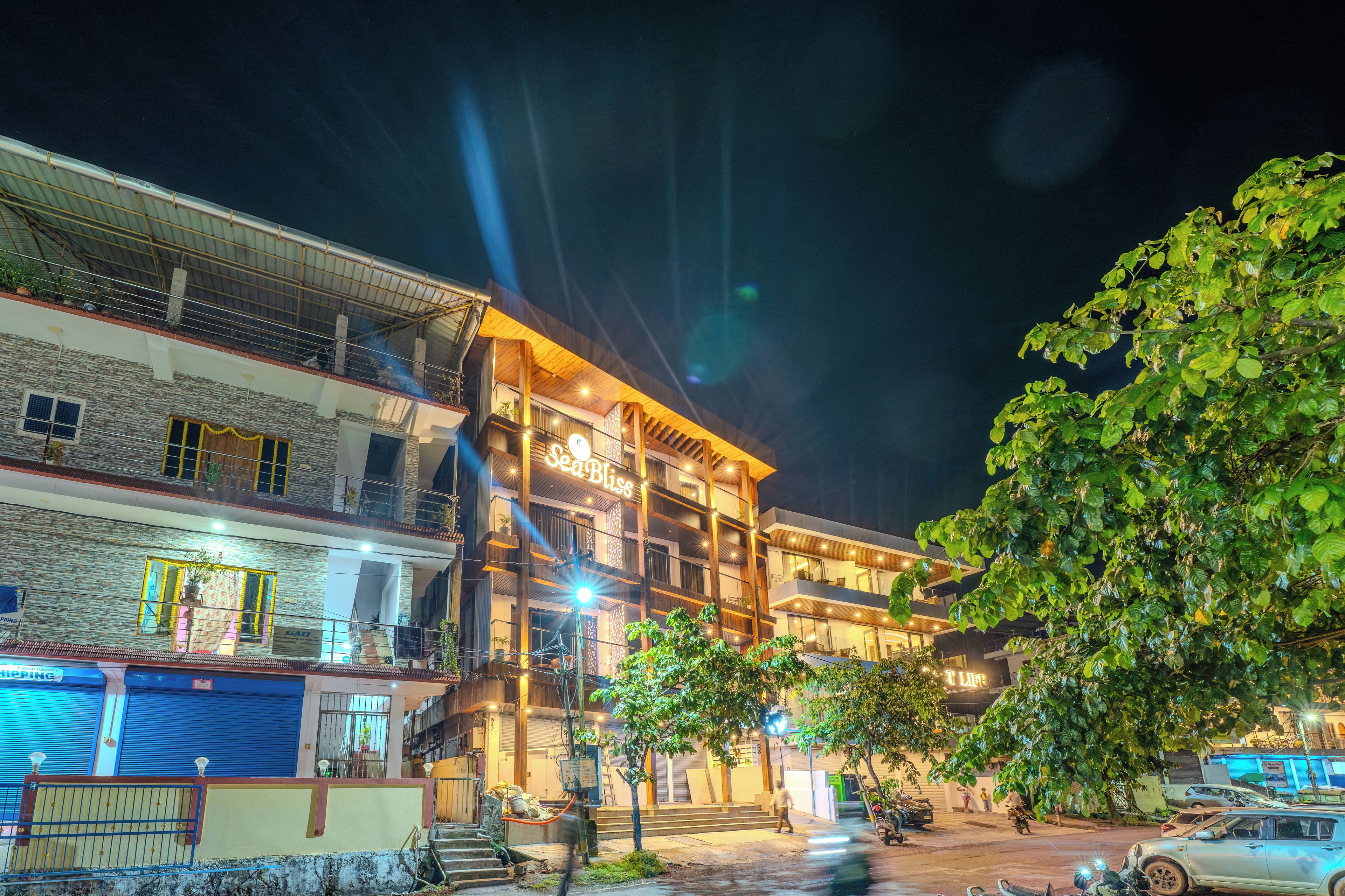 A multi-story building with a balcony and a sign that reads 'Sea Bliss.'