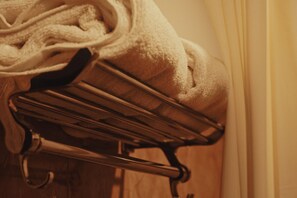 A metal drying rack with a towel on it, likely in a hotel room. - SEA BLISS (Port Blair)