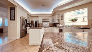 A spacious kitchen with granite countertops, stainless steel appliances, and a large island. - La Habra Heights Luxury Escape with 7 bedroom (Hacienda Heights)