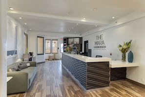A reception area with a modern design, a reception desk, and a seating area with a sofa. - 1 Block to Beach | Pool + Hot Tub + Rooftop Terrace | The Mara by AvantStay (Laguna Beach)