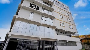 A multi-story hotel with a sign reading 'HOTEL' and balconies on each floor. - Deluxesree Residency (Bengaluru)