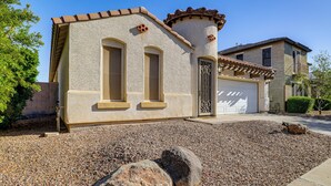 A house with a garage, a stone facade, and a gravel driveway. - Poolside Oasis: Group-Friendly Getaway in Phoenix! (Phoenix)