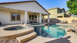 A residential property with a swimming pool, outdoor seating, and a covered patio area. - Poolside Oasis: Group-Friendly Getaway in Phoenix! (Phoenix)