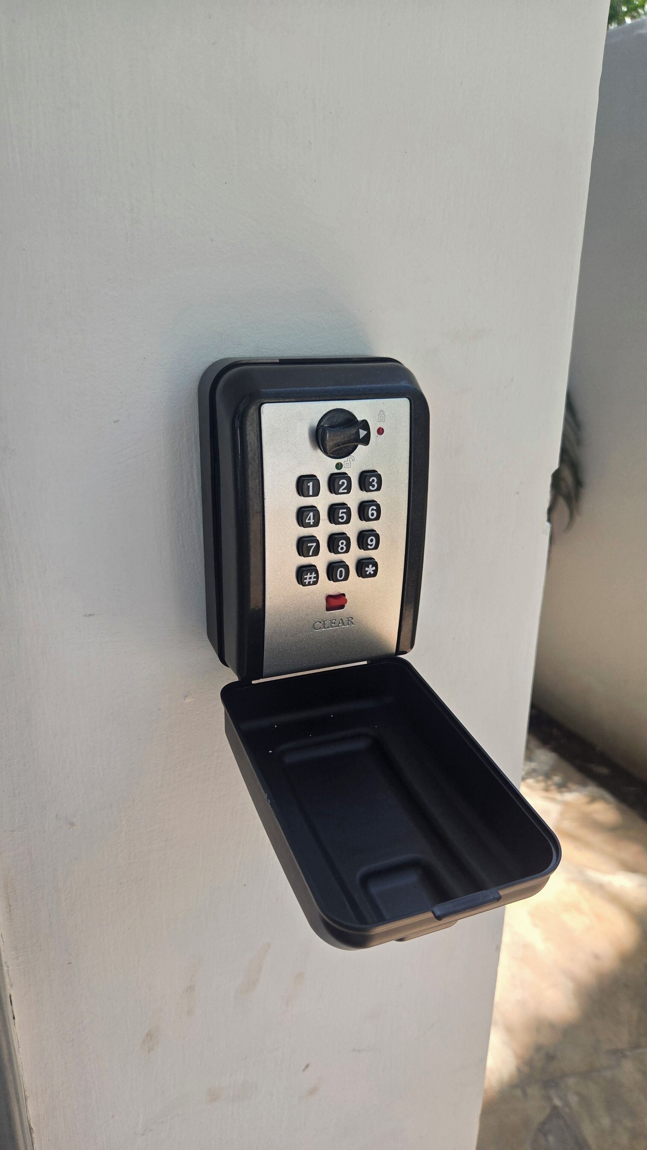 A keypad lock on a wall.