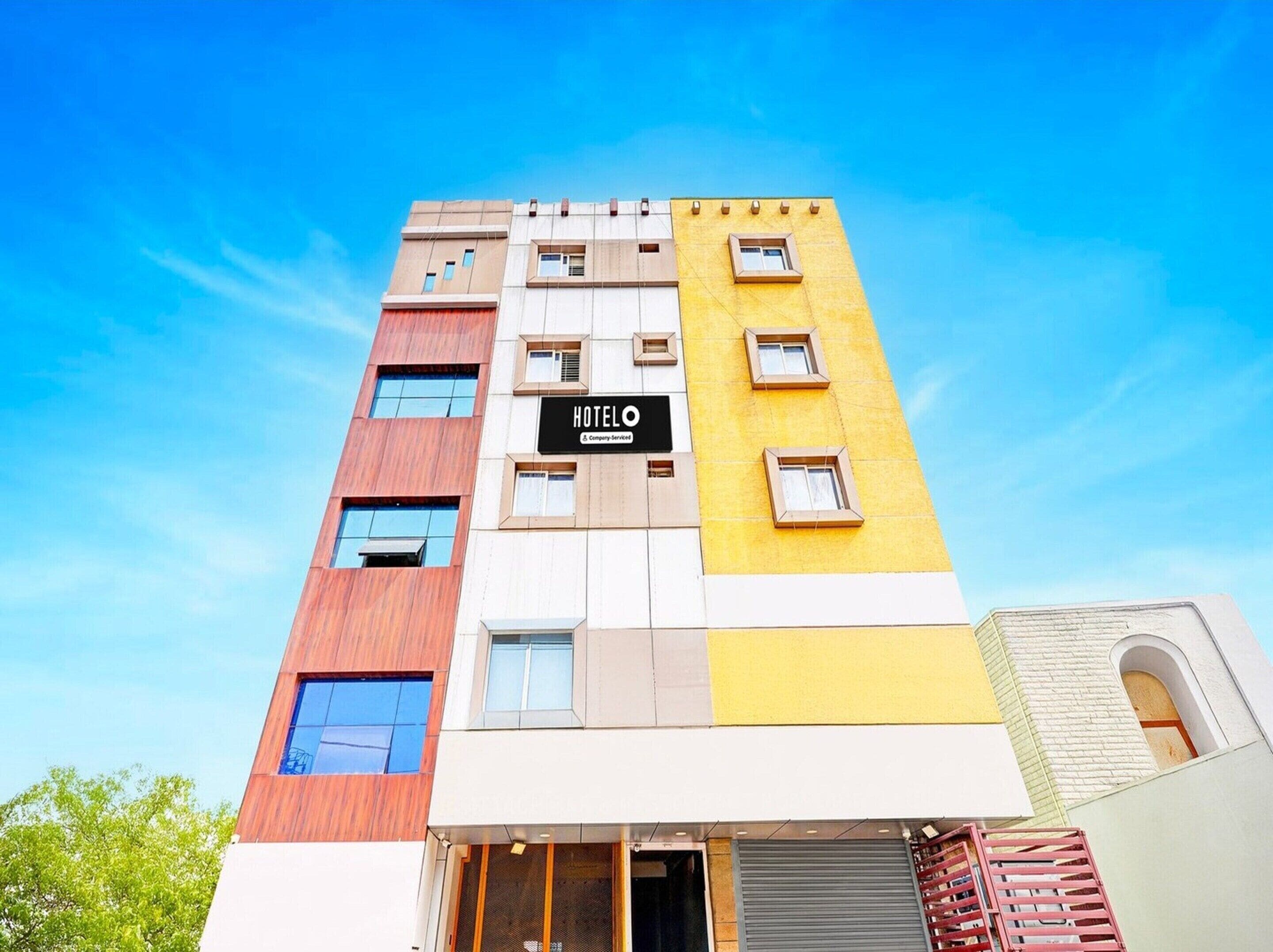 A multi-story hotel with a modern facade, a prominent 'HOTEL' sign, and a visible entrance.