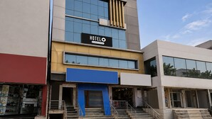A hotel with a modern facade, a prominent sign, and a staircase leading to the entrance. - Premium Sanjeevi Residency (Rajahmundry)