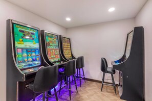 A row of slot machines with a bar area in between.