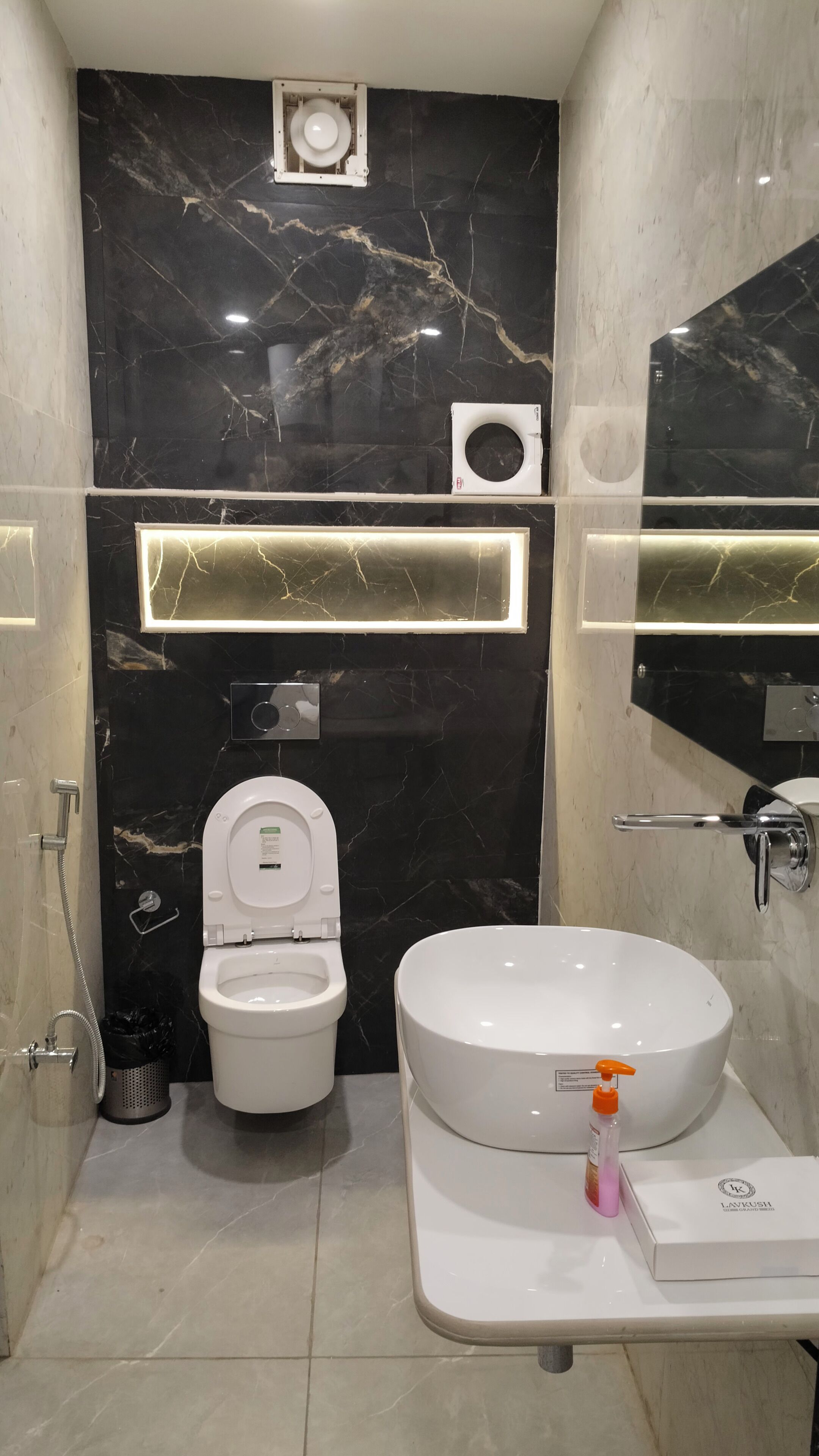 A modern bathroom with a toilet, bidet, and sink.