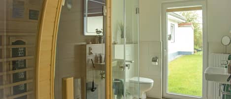 Shower, hair dryer, soap, toilet paper