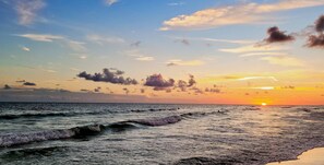 A sunset over the ocean with waves. - Ocean Breeze Stay and Play! 3BR + Game Room (Panama City Beach)