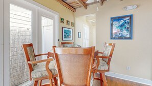 A dining area with a wooden ceiling, a ceiling fan, and a table with four chairs. - Charming cottage with private hot tub - one block to Duvall Street (Key West)