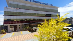 A modern hotel building with a prominent sign reading 'ARISE SUNSHINE HOTEL NAROK'. - Arise Sunshine Hotel (Narok)