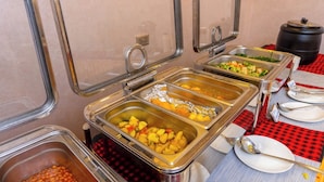 A buffet with various food options, including fruits, vegetables, and a soup station. - Arise Sunshine Hotel (Narok)
