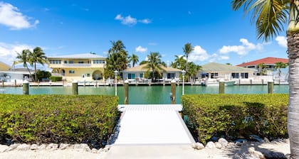 Waterfront home with dock, filet station, patio, balcony, & Cabana Club access