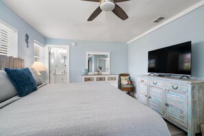 A bedroom with a bed, a television, a dresser, and a ceiling fan. - Waterfront Home w/ Private Dock, Outdoor Shower & Home Office - Dog-Friendly (Marathon)